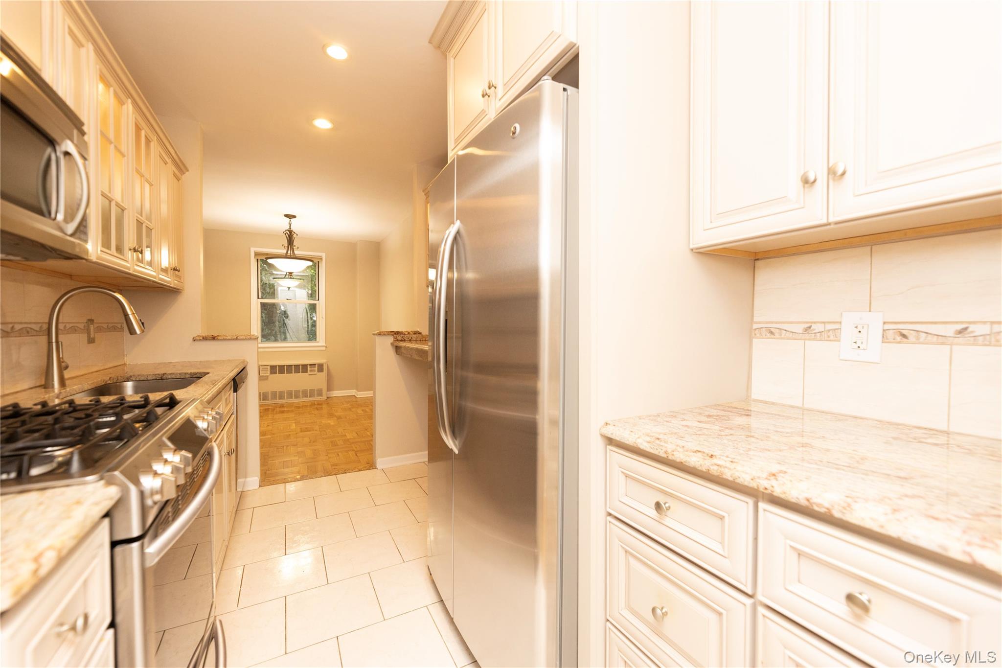 5550 Fieldston Road, Unit 1C ON 2 Bronx, NY 10471 - Photo 20 of 22 a kitchen with stainless steel appliances granite countertop a refrigerator and a sink