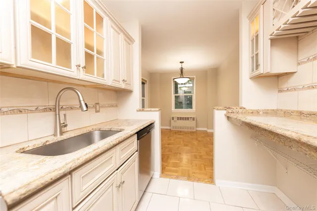 a kitchen with granite countertop a sink and a stove