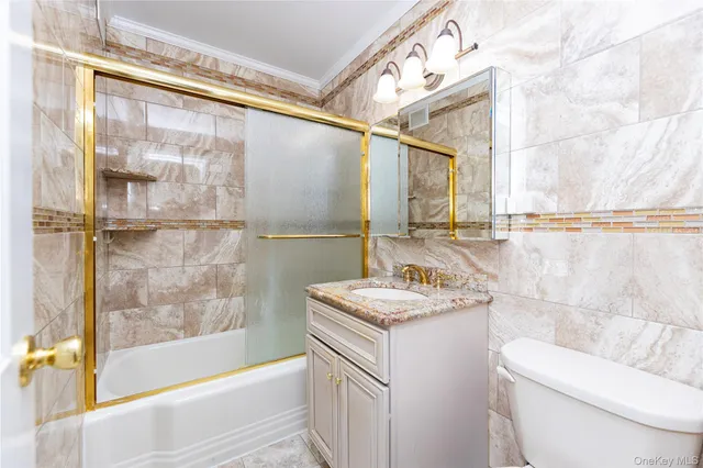 a bathroom with a sink and mirror with bathtub