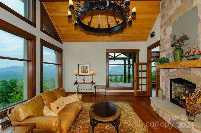 0 Golden Ridge Drive, Unit 133 Lake Lure, NC 28746 - Photo 13 of 14 a living room with furniture a fireplace and a chandelier