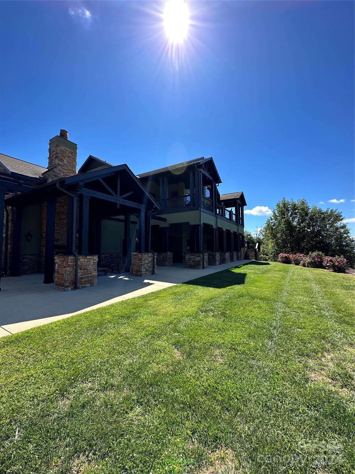 0 Golden Ridge Drive, Unit 133 Lake Lure, NC 28746 - Photo 9 of 14 a view of a big house with a big yard plants and large trees