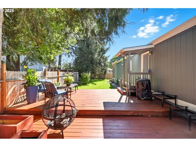 a view of a backyard with sitting area