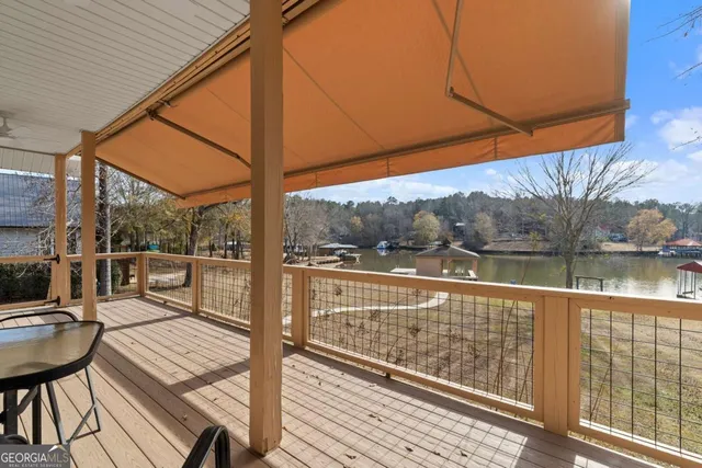 a view of a balcony with lake view and wooden floor