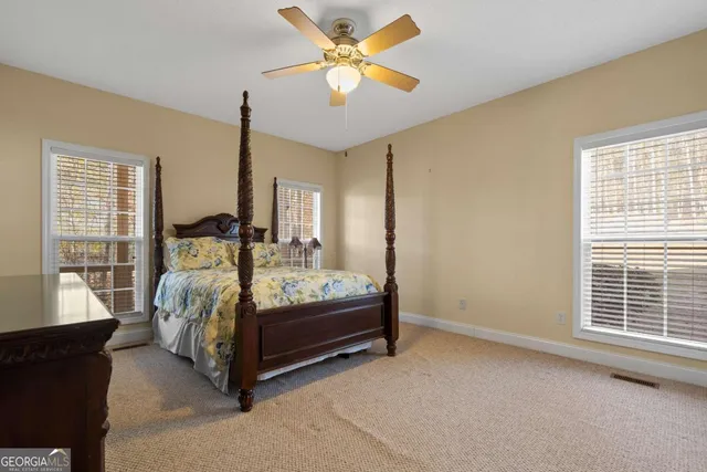 a bedroom with a bed and window