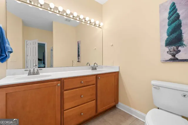 a bathroom with a double vanity sink and a toilet