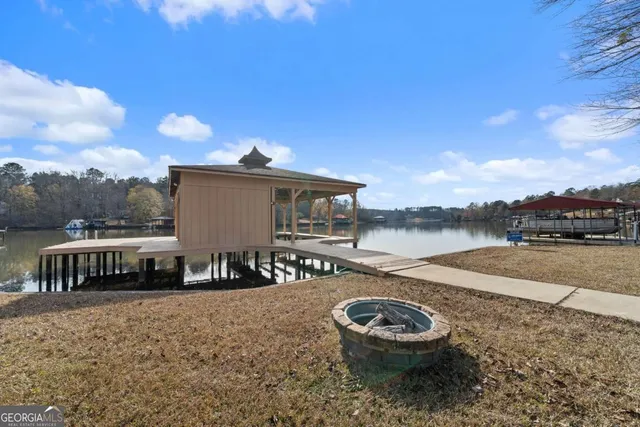 a backyard of a house with barbeque oven table and chairs