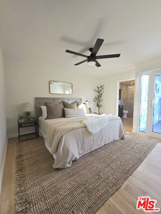 2520 Midvale Avenue Los Angeles, CA 90064 - Photo 13 of 25 a bedroom with a bed and a chandelier