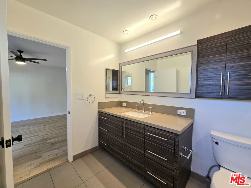 2520 Midvale Avenue Los Angeles, CA 90064 - Photo 16 of 25 a bathroom with a granite countertop sink toilet and mirror