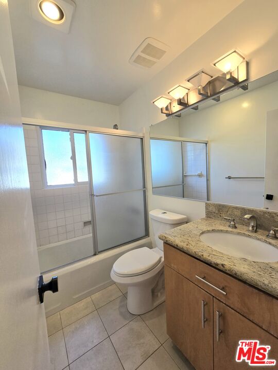 2520 Midvale Avenue Los Angeles, CA 90064 - Photo 20 of 25 a bathroom with a granite countertop sink a toilet a mirror and shower