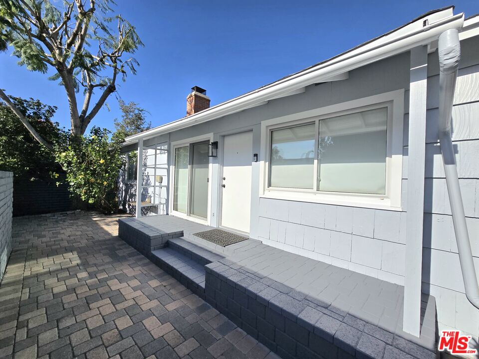 2520 Midvale Avenue Los Angeles, CA 90064 - Photo 4 of 25 a view of a house with a large window and wooden fence