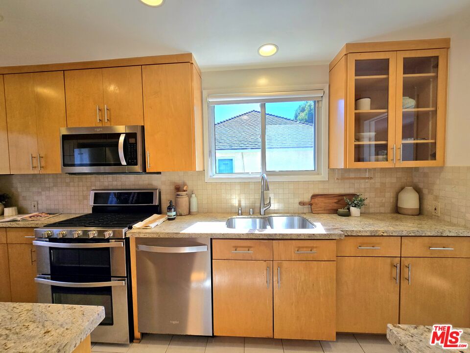 2520 Midvale Avenue Los Angeles, CA 90064 - Photo 10 of 25 a kitchen with stainless steel appliances granite countertop a stove a sink and a microwave