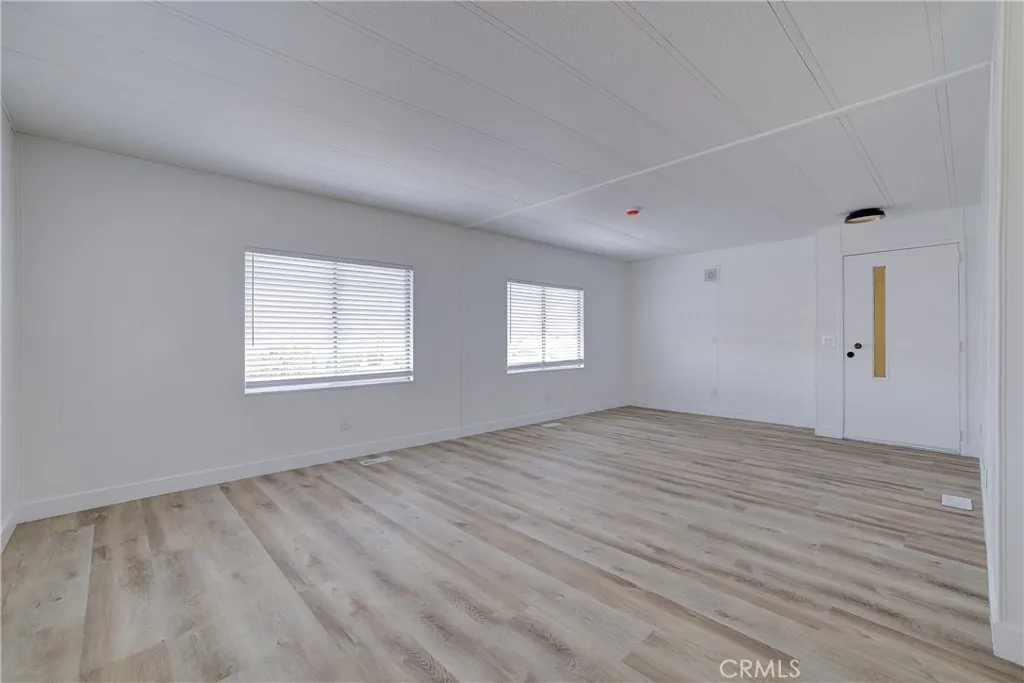 3700 Buchanan Street, Unit 164 Riverside, CA 92503 - Photo 7 of 40 a view of an empty room with wooden floor and a window