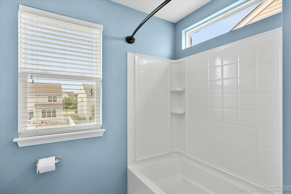 5734 Oak Ridge Way Lisle, IL 60532 - Photo 15 of 28 a bathroom with a bathtub and a shower