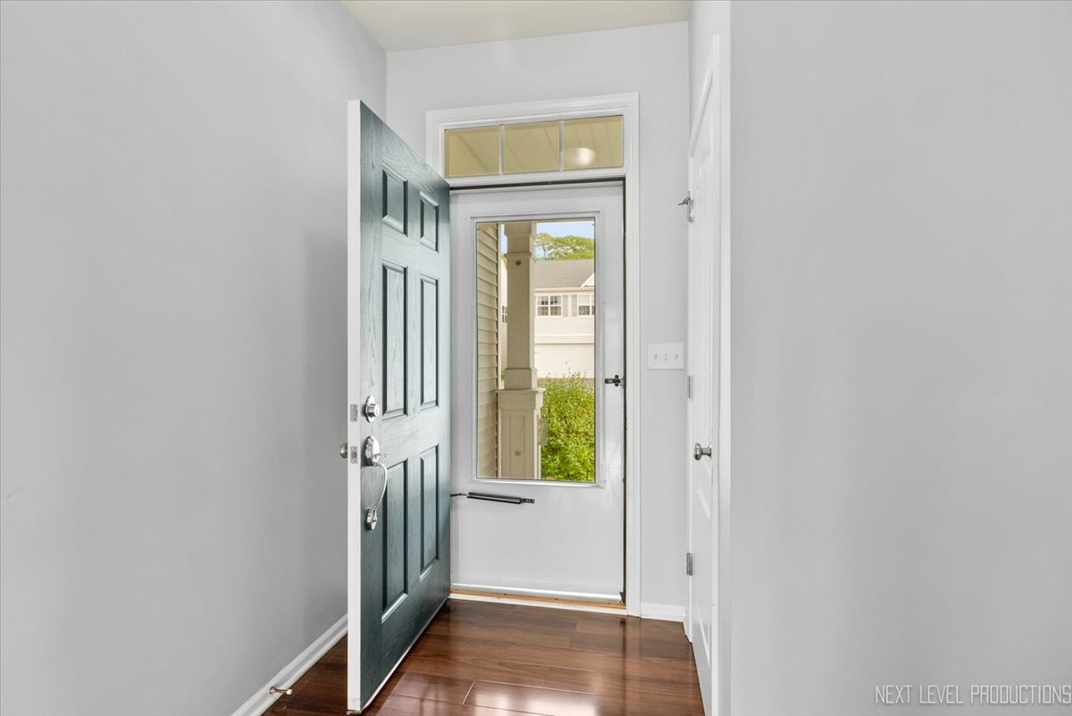 5734 Oak Ridge Way Lisle, IL 60532 - Photo 5 of 28 a view of a hallway with wooden floor and a window