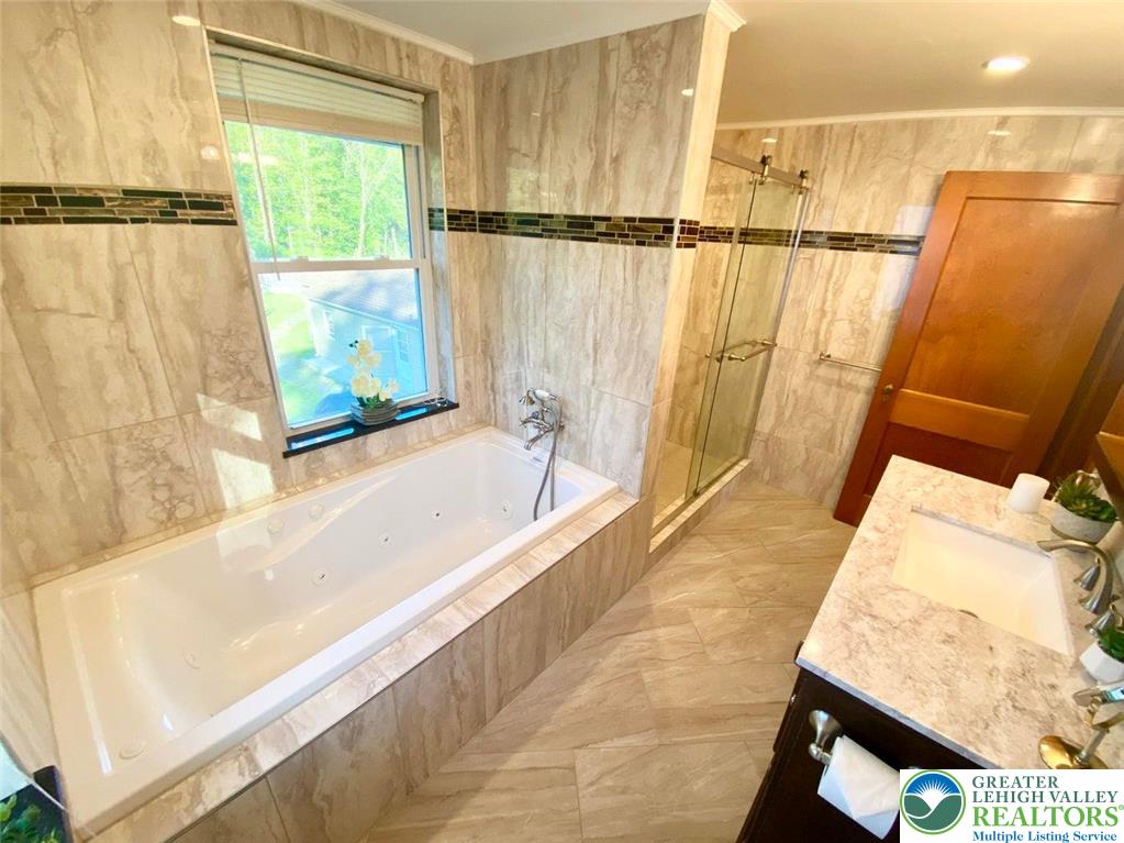 244 Learn Road Tannersville, PA 18372 - Photo 23 of 69 a bathroom with a bathtub and a shower