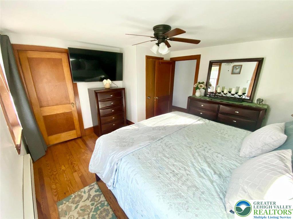 244 Learn Road Tannersville, PA 18372 - Photo 10 of 69 a bedroom with a bed and a flat screen tv