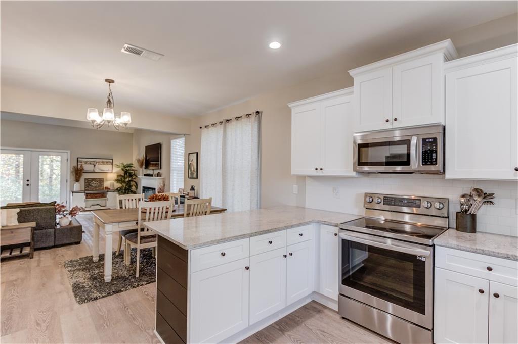 6137 Timberidge Drive Gainesville, GA 30506 - Photo 11 of 50 a kitchen with a stove a sink and a microwave