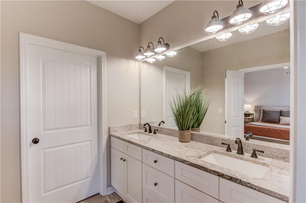 6137 Timberidge Drive Gainesville, GA 30506 - Photo 19 of 50 a bathroom with a double vanity sink and a mirror