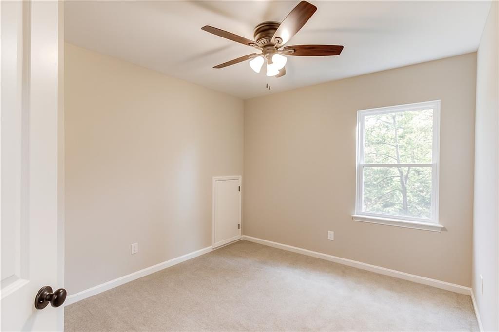 6137 Timberidge Drive Gainesville, GA 30506 - Photo 31 of 50 an empty room with a window and a fan