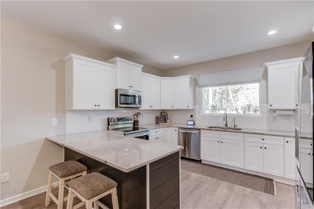 6137 Timberidge Drive Gainesville, GA 30506 - Photo 9 of 50 a kitchen with a sink window and cabinets