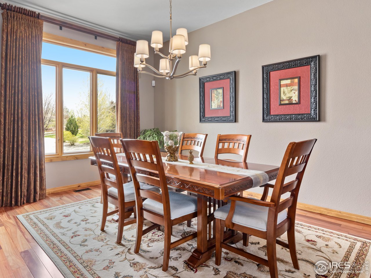 8193 Admiral Drive Windsor, CO 80528 - Photo 14 of 39 a view of a dining room with furniture a chandelier and wooden floor
