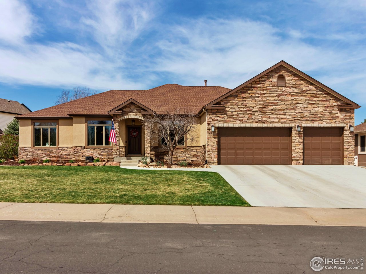 8193 Admiral Drive Windsor, CO 80528 - Photo 2 of 39 a front view of a house with a garden and yard