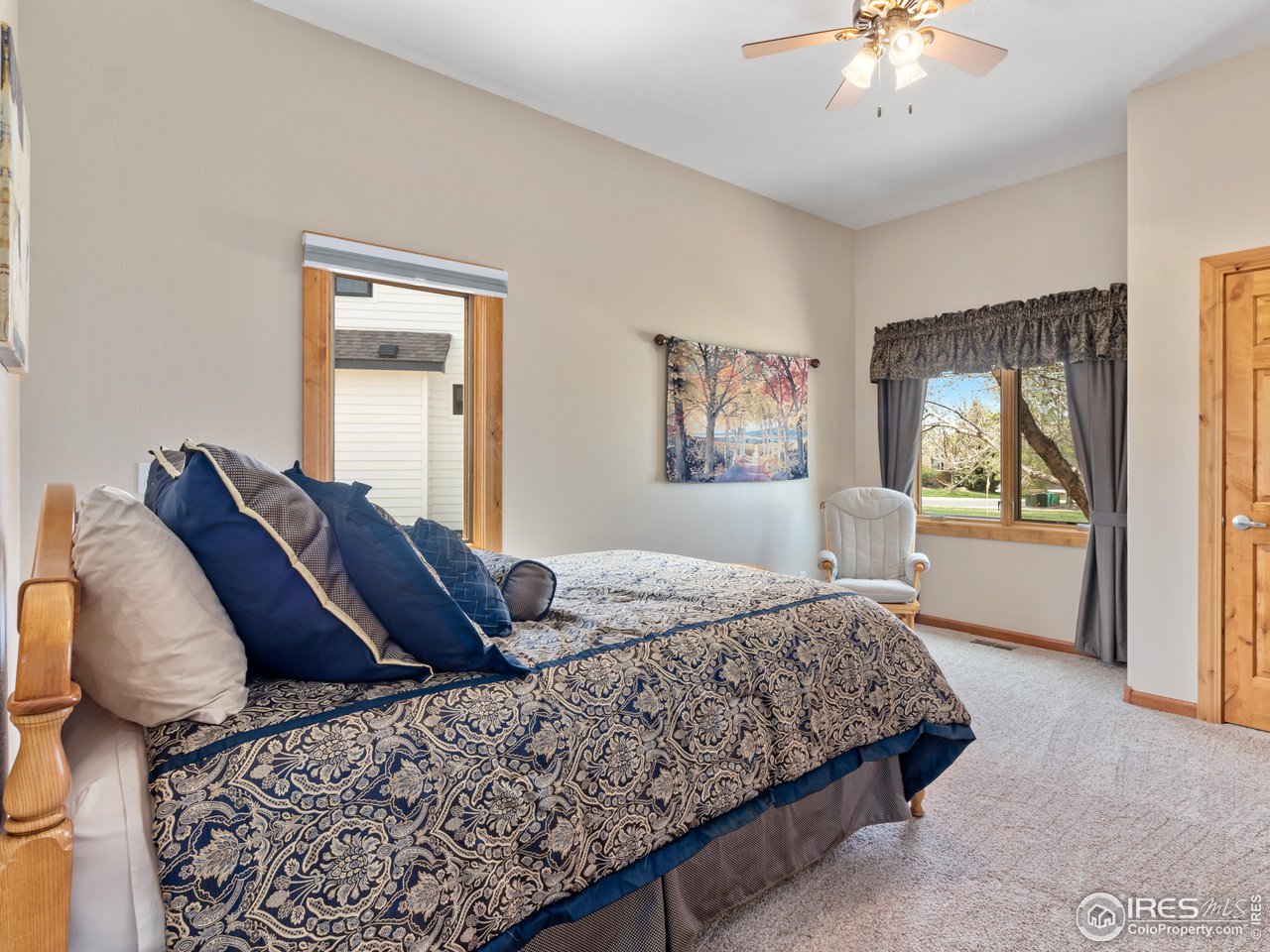 8193 Admiral Drive Windsor, CO 80528 - Photo 22 of 39 a bed room with a bed and a painting on the wall