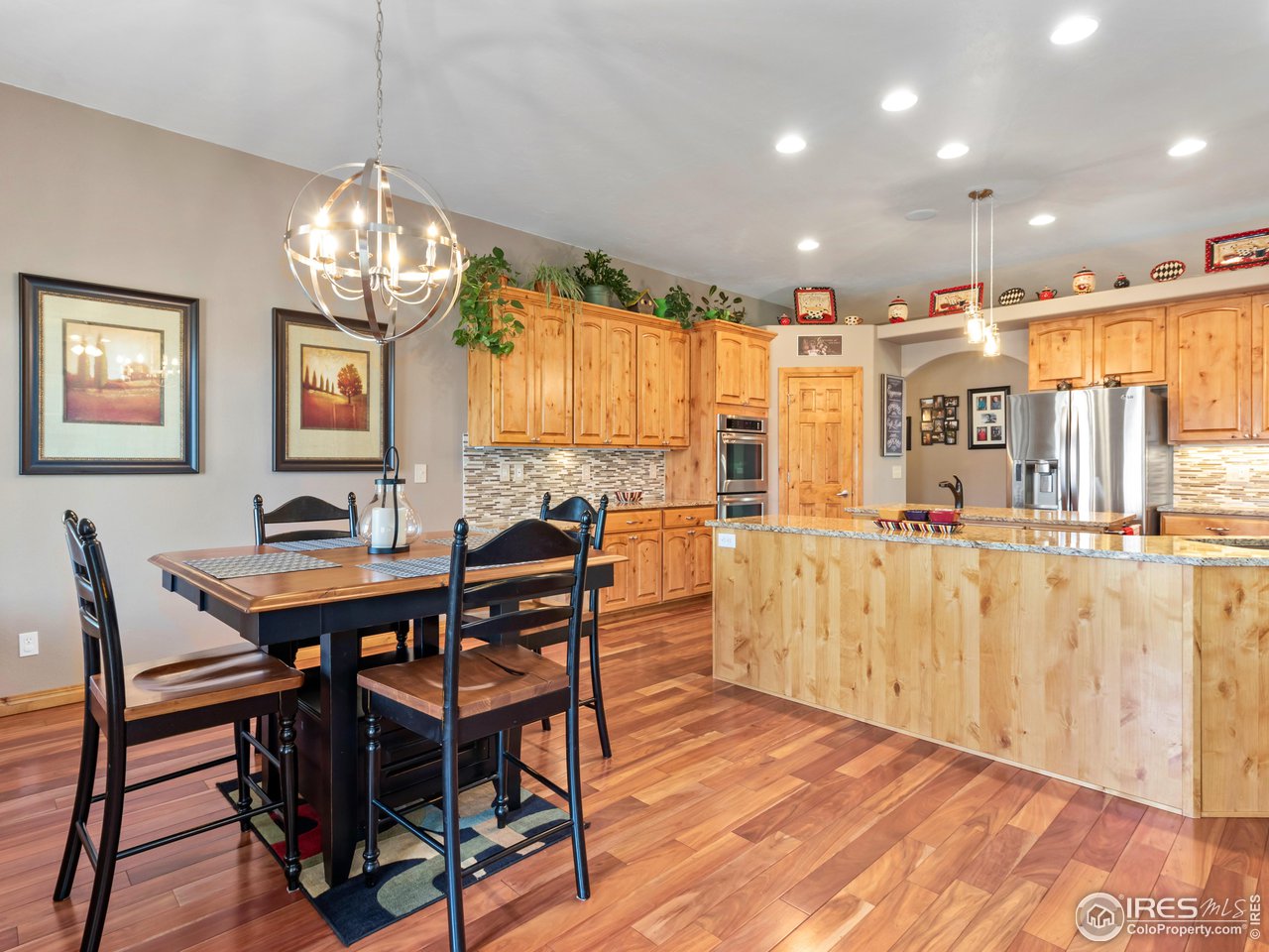 8193 Admiral Drive Windsor, CO 80528 - Photo 10 of 39 a view of a dining room with furniture window and wooden floor
