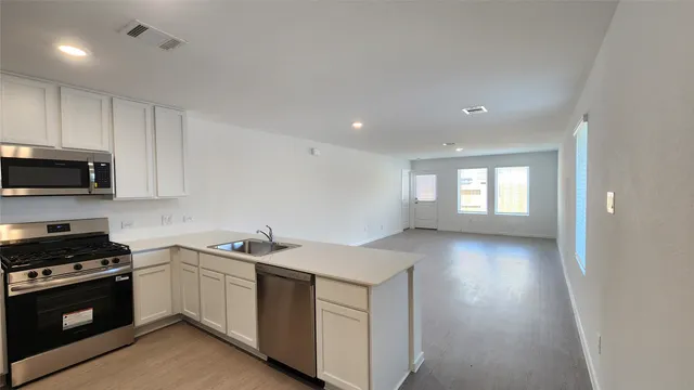 a view of a kitchen with a sink and a window