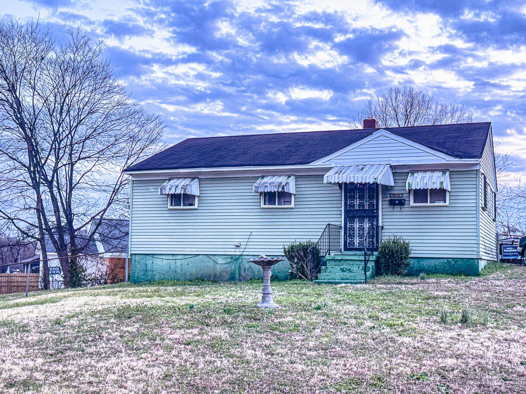 273 Carbon Road Memphis, TN 38109 - Photo 2 of 2 View of front of house featuring roof with shingles and a chimney