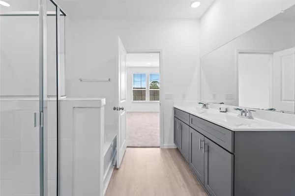 a bathroom with a double vanity sink a and mirror