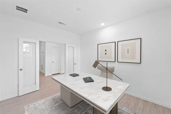 a view of a room that has a table and chairs in it