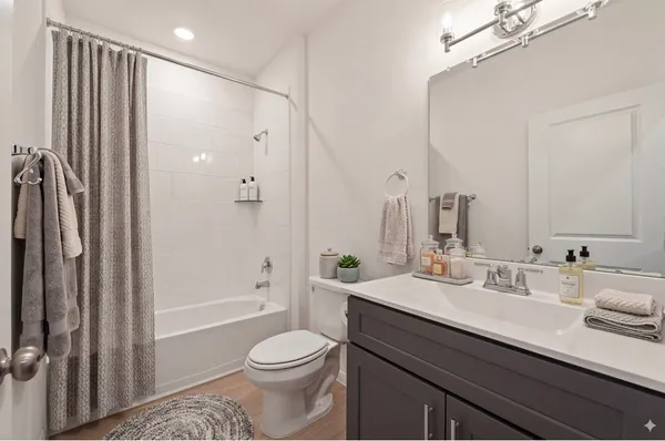 a bathroom with a double vanity sink toilet and shower