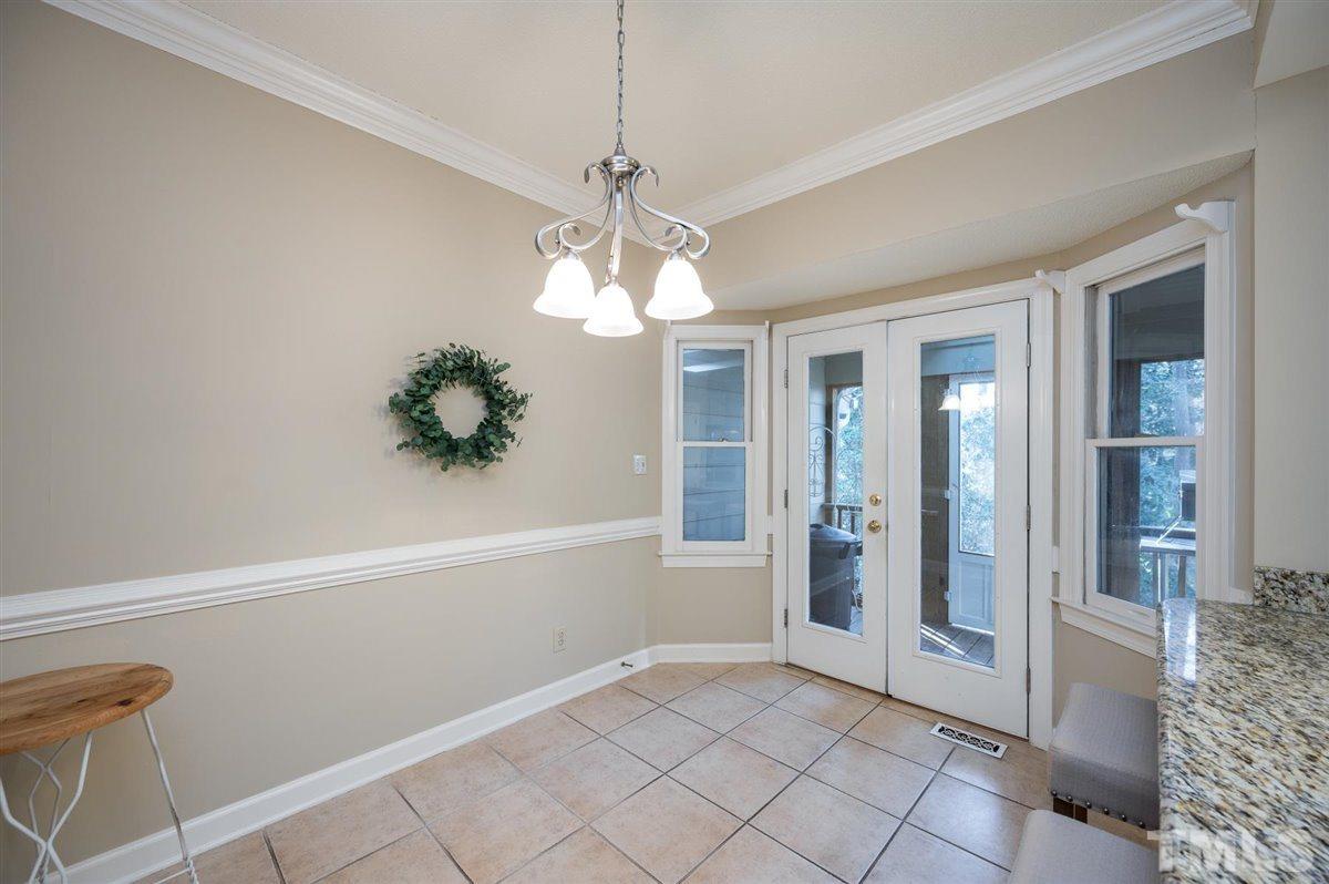 7921 Footman Way Raleigh, NC 27615 - Photo 14 of 28 a view of a livingroom with a chandelier fan and windows