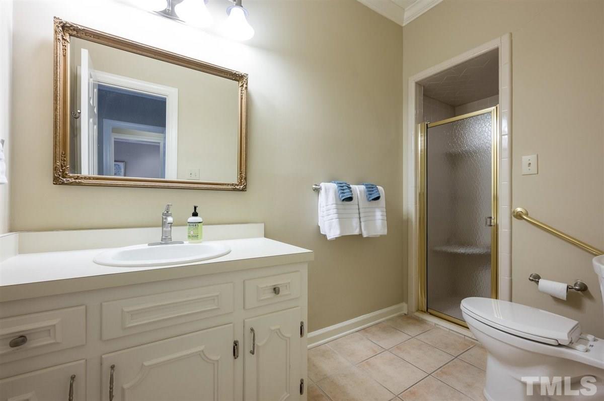 7921 Footman Way Raleigh, NC 27615 - Photo 17 of 28 a bathroom with a sink and a mirror