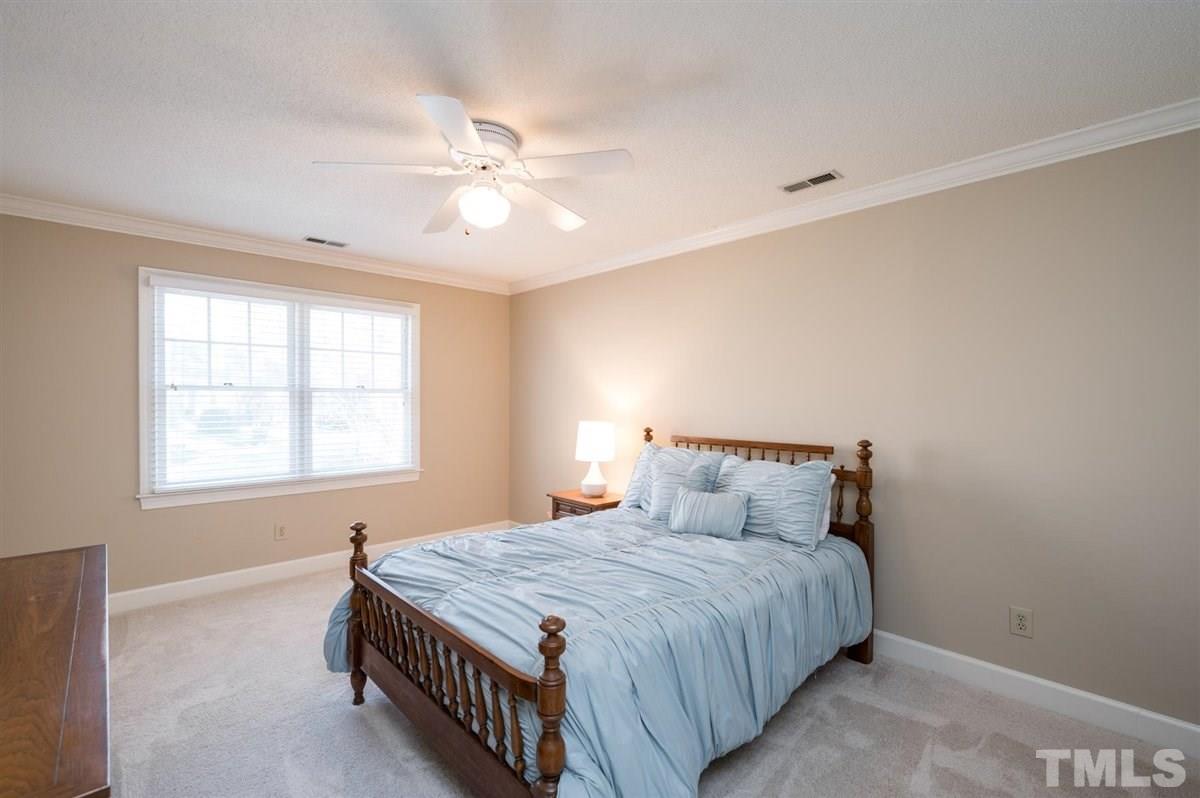 7921 Footman Way Raleigh, NC 27615 - Photo 18 of 28 a bedroom with a large bed and a window
