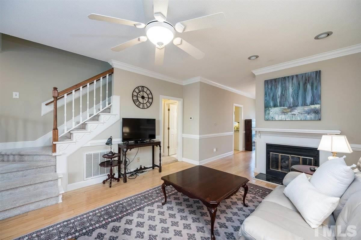 7921 Footman Way Raleigh, NC 27615 - Photo 3 of 28 a living room with furniture and a fireplace
