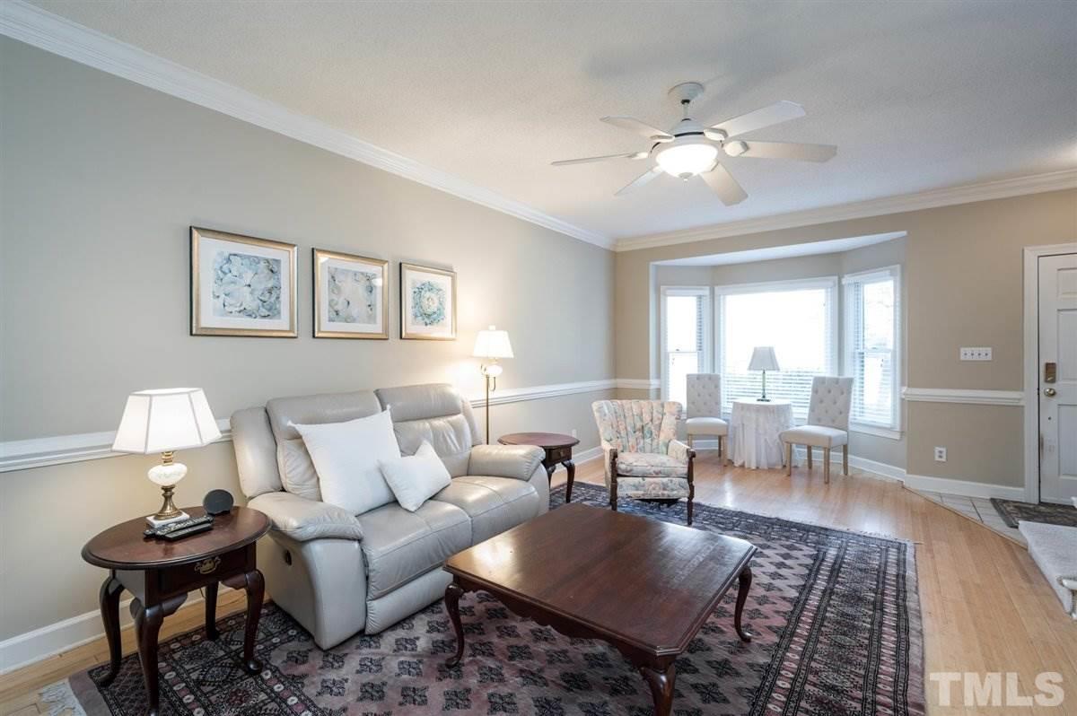7921 Footman Way Raleigh, NC 27615 - Photo 4 of 28 a living room with furniture and a large mirror next to a window