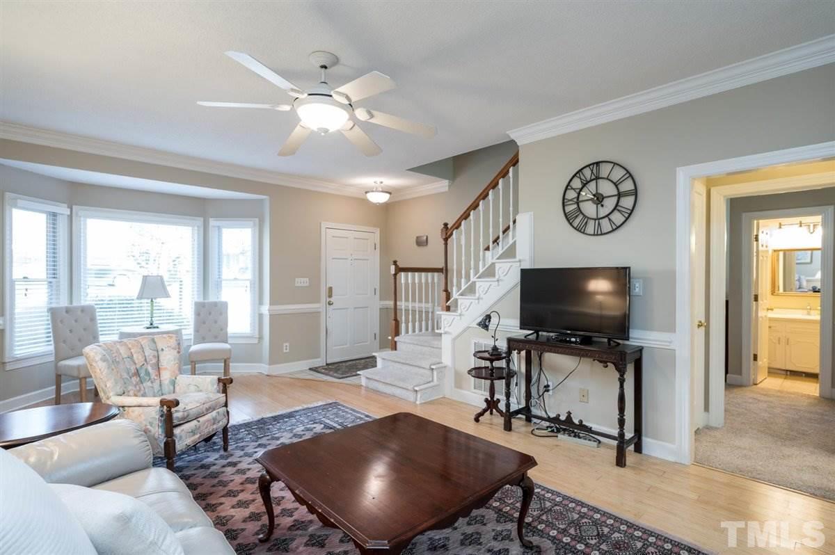 7921 Footman Way Raleigh, NC 27615 - Photo 7 of 28 a living room with furniture and a flat screen tv