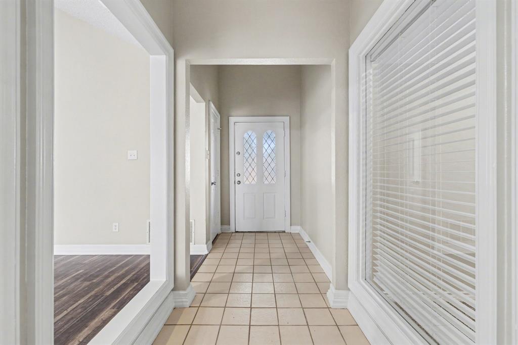 505 Springhill Drive Hurst, TX 76054 - Photo 2 of 25 a view of a hallway view with wooden floor and staircase