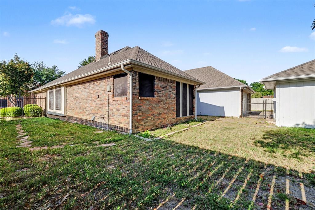 505 Springhill Drive Hurst, TX 76054 - Photo 23 of 25 a front view of a house with garden