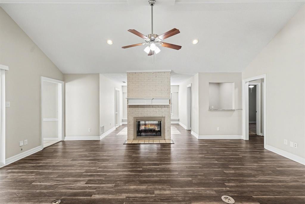 505 Springhill Drive Hurst, TX 76054 - Photo 5 of 25 a living room with fireplace and wooden floor