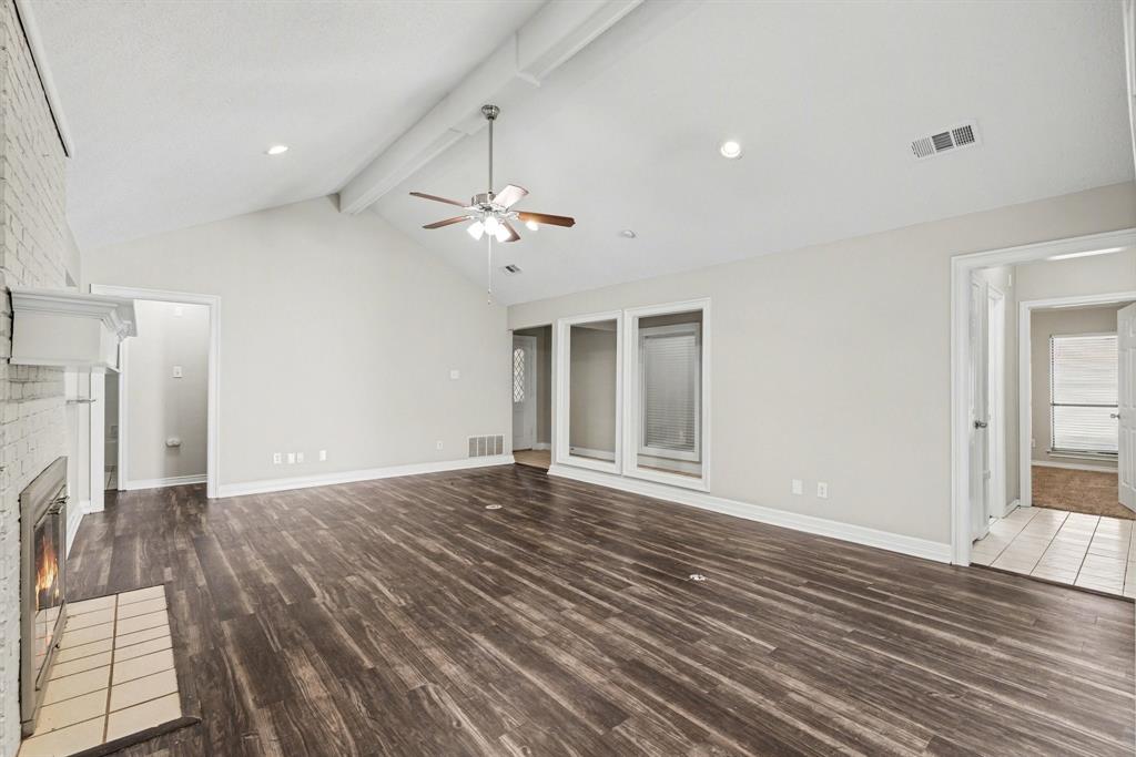 505 Springhill Drive Hurst, TX 76054 - Photo 6 of 25 an empty room with wooden floor and ceiling fan