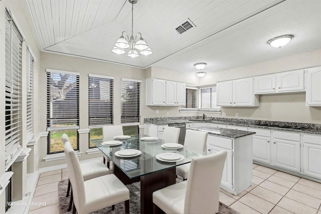 505 Springhill Drive Hurst, TX 76054 - Photo 10 of 25 a dining room with granite countertop furniture a chandelier a large window and appliances