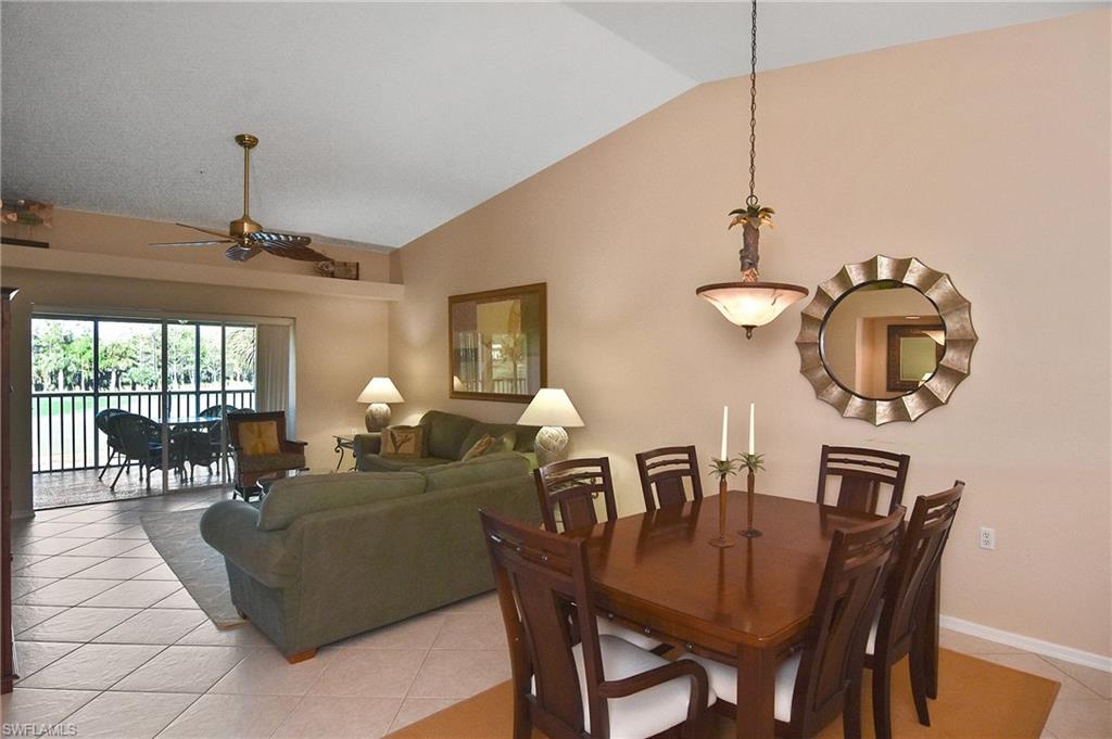 a living room with furniture a chandelier and a window