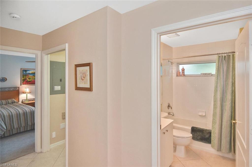 3870 Sawgrass Way, Unit 2521 Naples, FL 34112 - Photo 11 of 46 a bathroom with a glass shower door