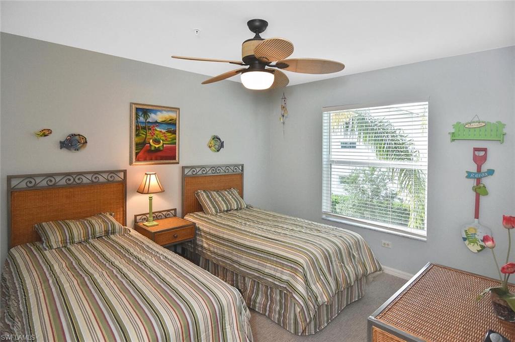 3870 Sawgrass Way, Unit 2521 Naples, FL 34112 - Photo 14 of 46 a bedroom with a bed and a window