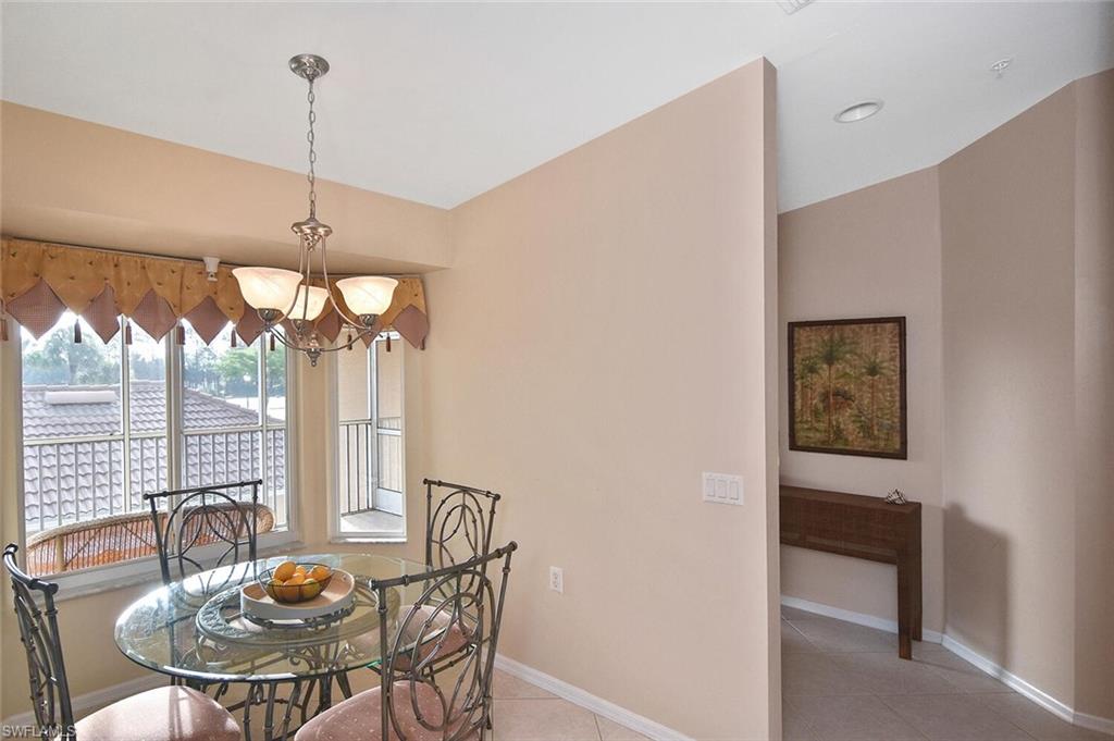 3870 Sawgrass Way, Unit 2521 Naples, FL 34112 - Photo 22 of 46 a view of a dining room with furniture window and outside view