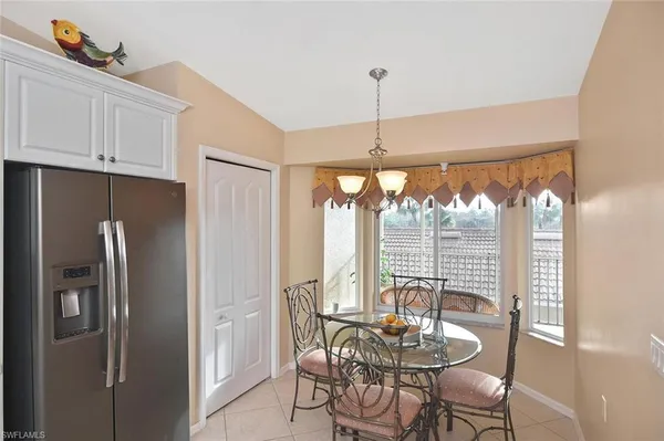a kitchen with stainless steel appliances granite countertop a refrigerator and white cabinets