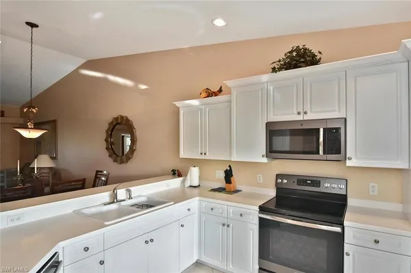 a kitchen with a sink stove and microwave